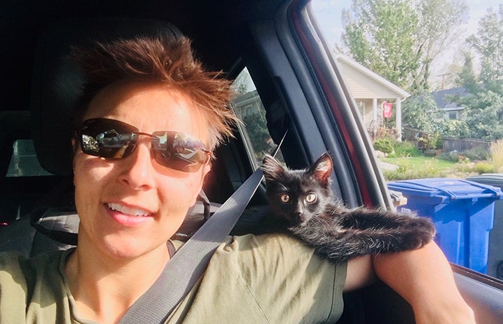 Woman in a car with Rafa the kitten on her shoulder