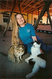 Vivian Ebbs in Cat World petting some cats