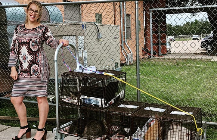 Lauren Miller pulling a cart covered in humane traps containing community cats