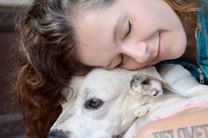 Animal advocate and musician Neko Case snuggling with a dog