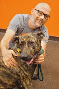 Moby petting a dog at Best Friends