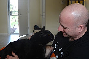 Phanty the black cat with Matthew Soskin