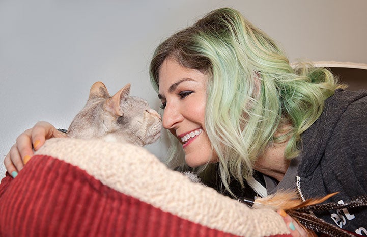 Samantha Bell DiGenova snuggling with a cat