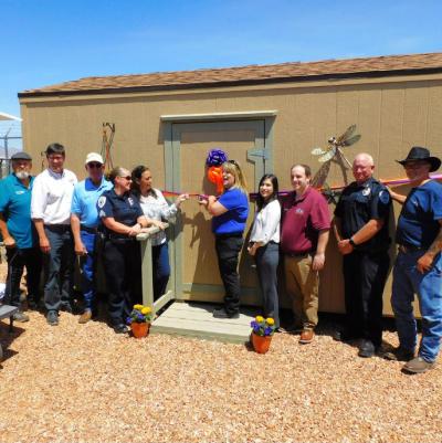 A group of people at the ribbon cutting to open the Benson Animal Shelter cat shed