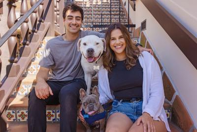 Brew and Julien on some stairs with their adopters, Alyssa Leon and Tommy Rigdon