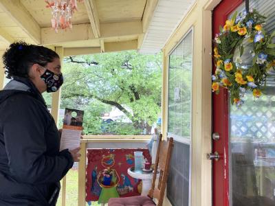 Masked person visiting a home about the TNVR program