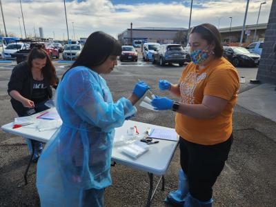 People in protective gear outside with a swab and tube as part of the distemper outbreak