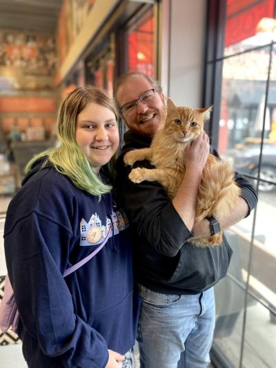 Mariano the orange tabby cat with his new people