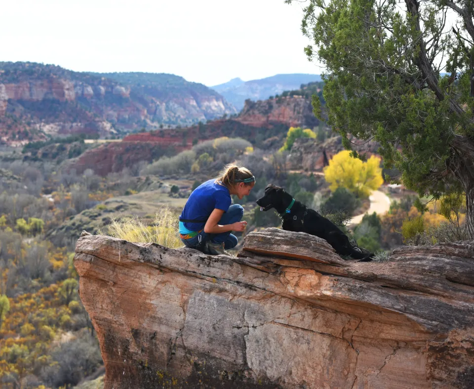 Person on a hike with a dog in Southern Utah
