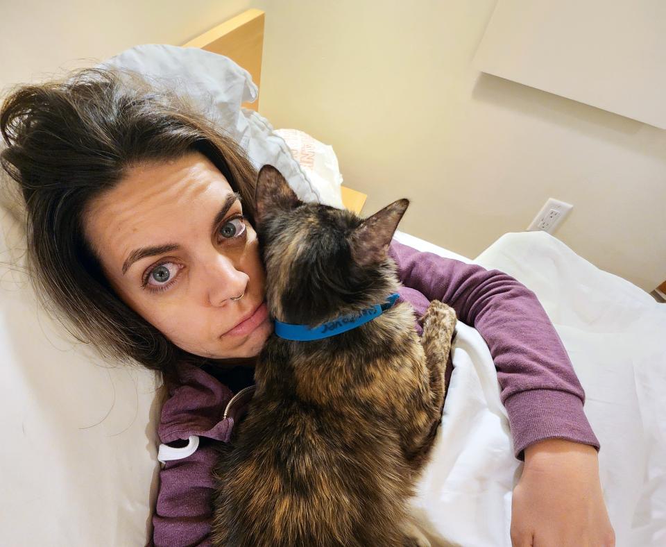 Katy Bentz in bed on a sleepover with Beauty the cat