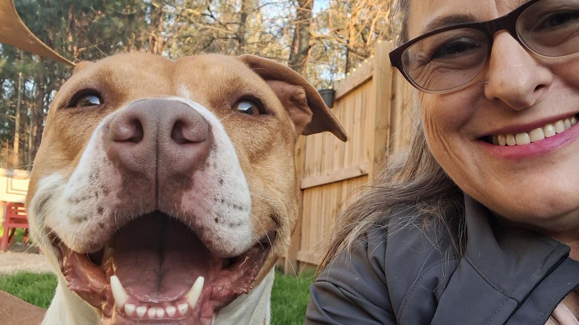 Mama the dog with a smiling woman