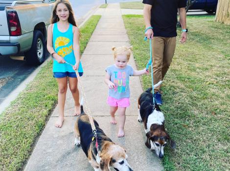 The Cochran family walking two basset hounds