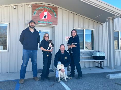 Staff from the Inyo County Animal Shelter outside with a couple dogs