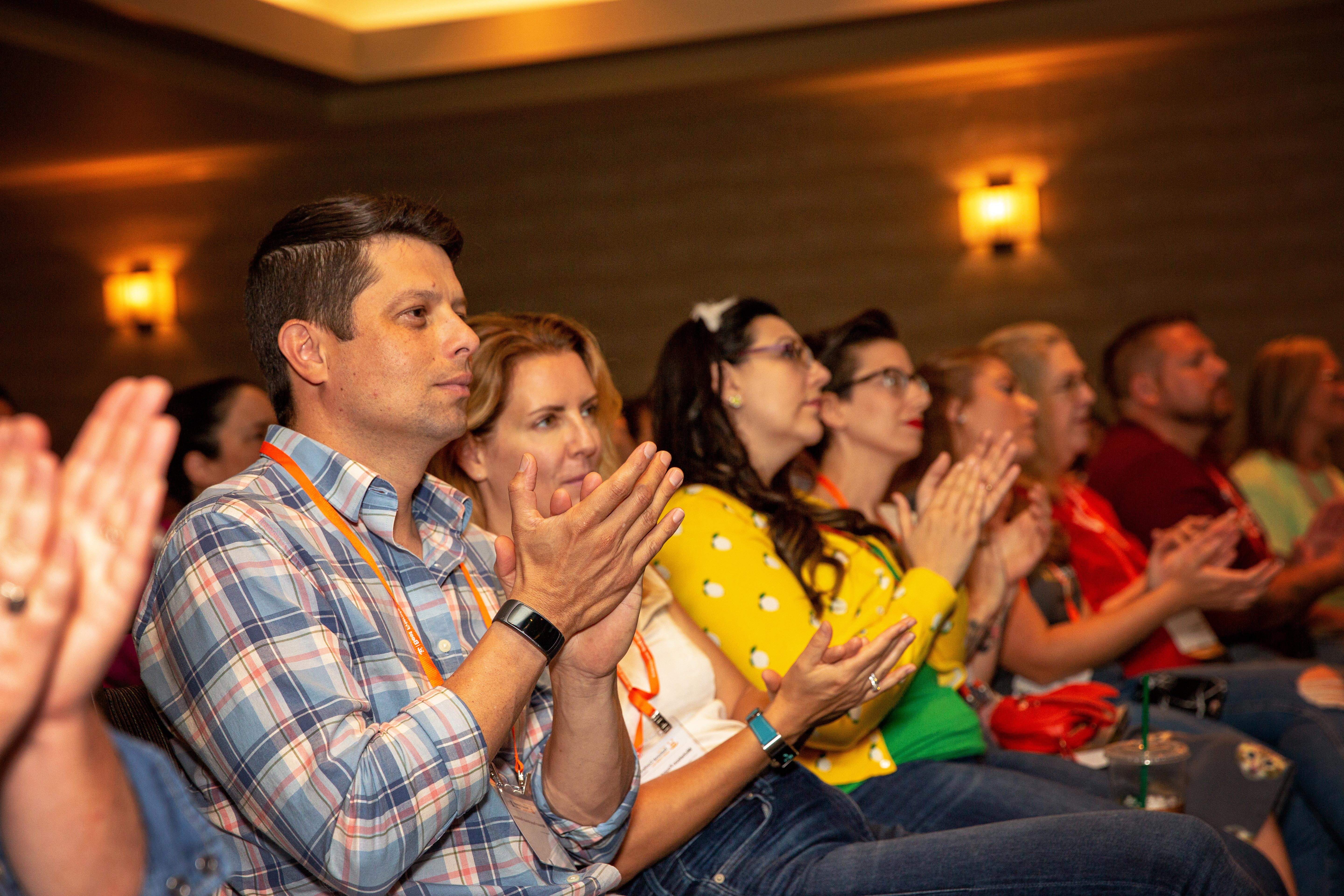 Audience members clapping at a Best Friends National Conference session
