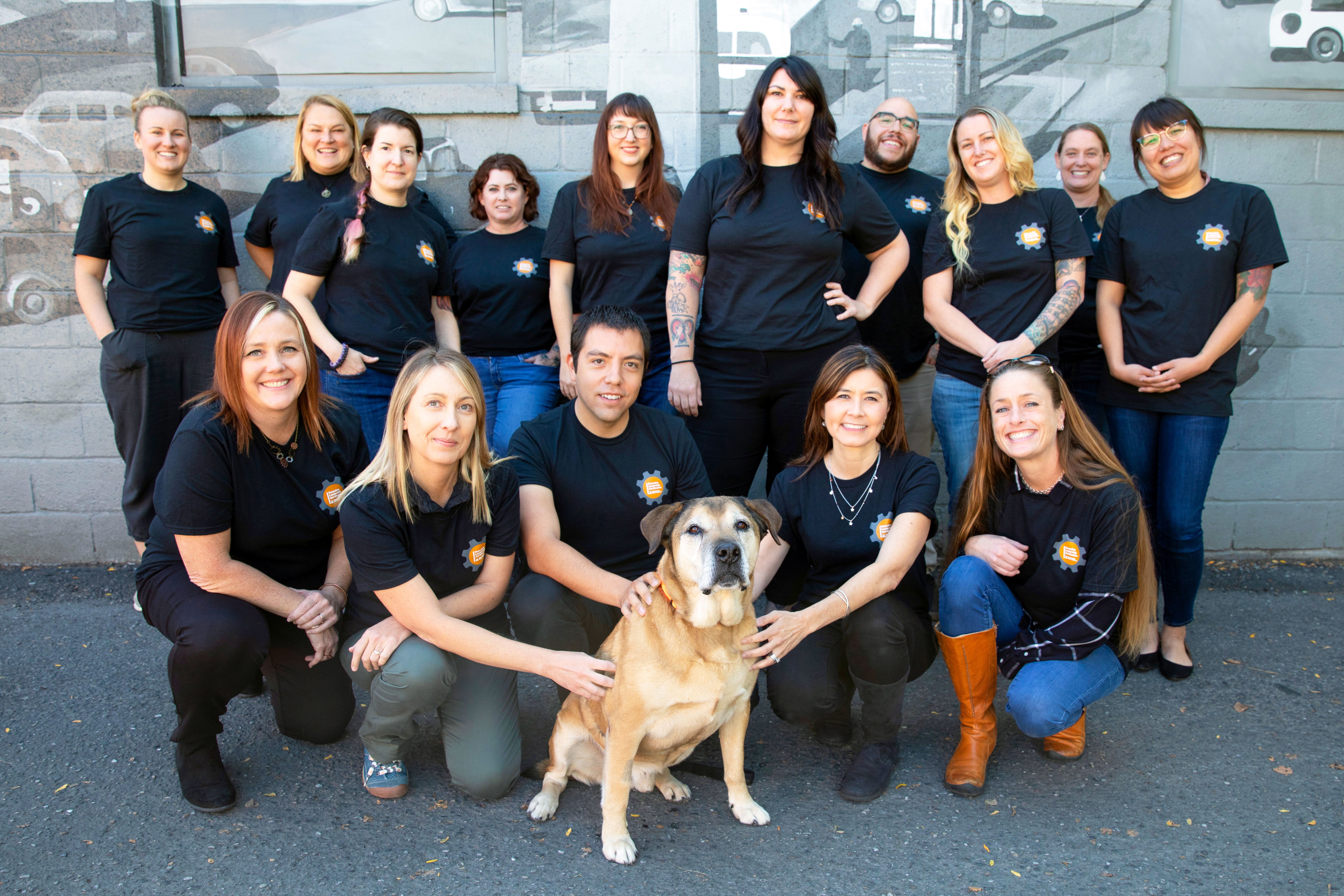 Group shot of first graduates from the SUU Executive Leadership Certification with a dog
