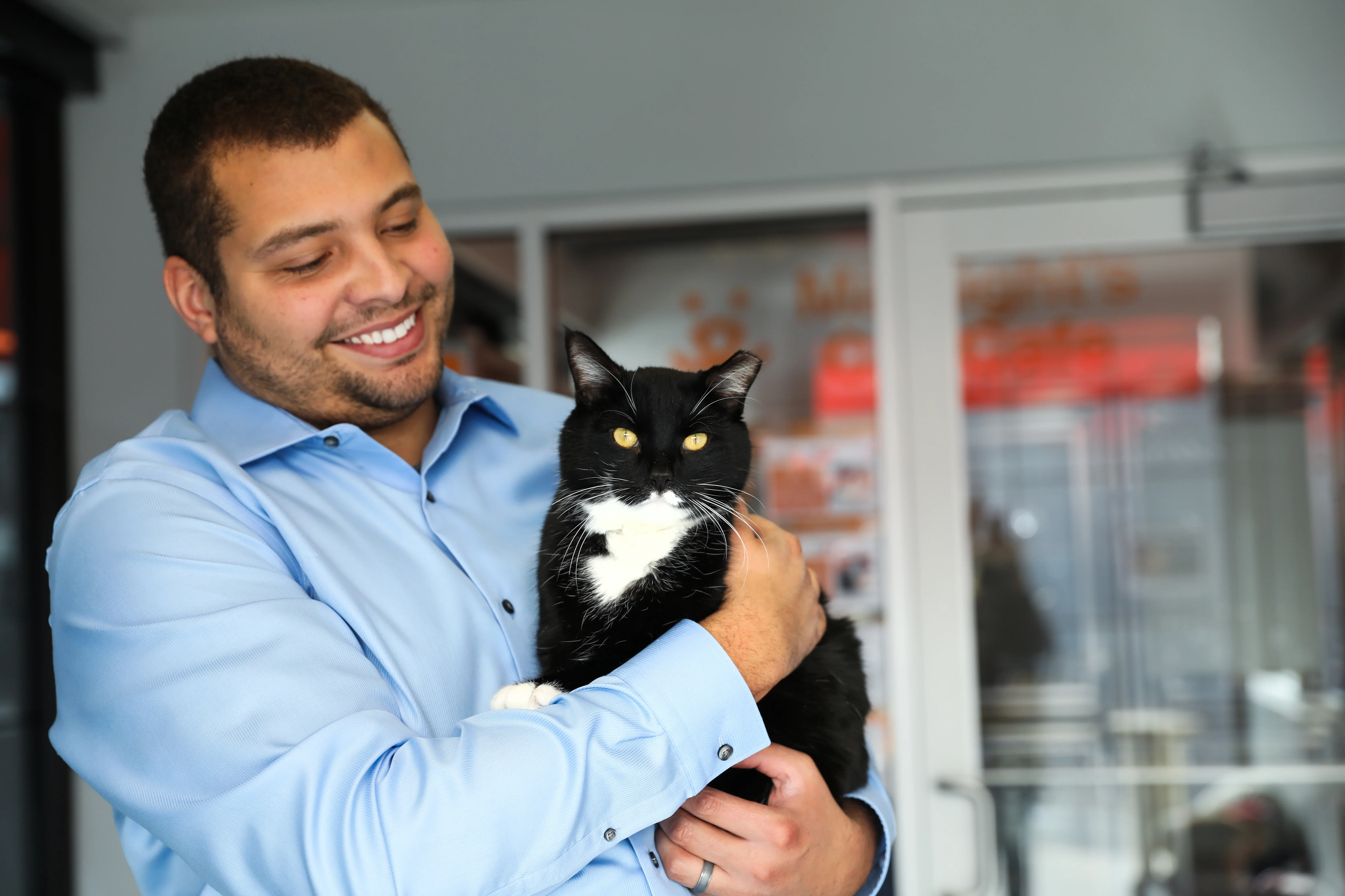 Smiling person holding a cat