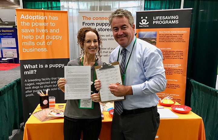 Elizabeth Oreck in front of a booth with Assembly member O'Donnell