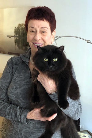 Barb McDaniel holding Fern the black cat