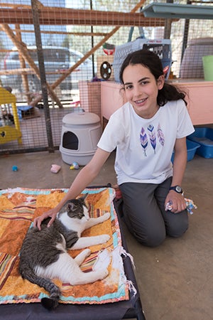 Lily Dick posing next to a cat at Best Friends Animal Sanctuary