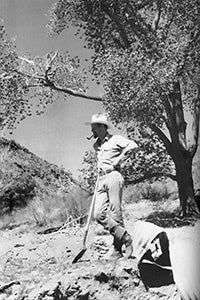 Paul Eckhoff surveying Angel Canyon leaning on a shovel