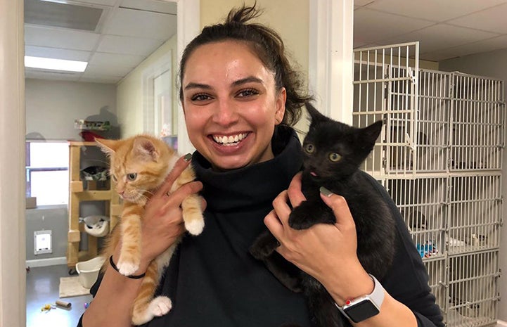 Smiling woman holding Ravioli and Tuffy, two kittens she'd adopted