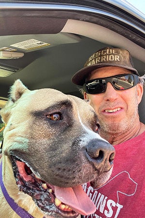 Volunteer Danny Bress ready for a ride in his truck with Beefy the dog