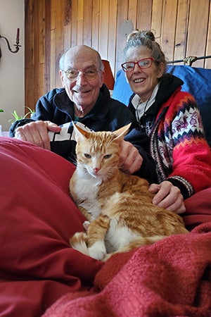 Newton the cat with his new family