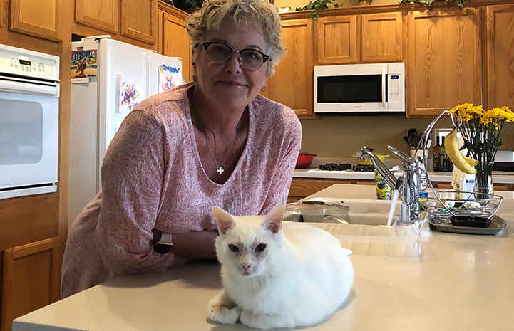 Dianne Beckman with Sonya, the white cat she's adopted