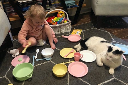 Russell the cat having a tea party with the child in his new family
