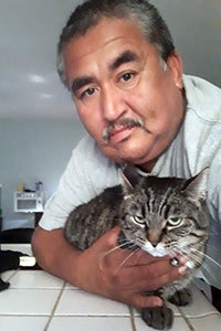 Armando with Sassy the brown tabby cat 