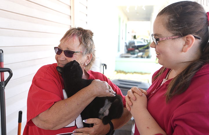 Not all community cats are feral. Some learn to trust their people ― like colony caregiver Cindy Hide, who embraces Blackie after her spay surgery