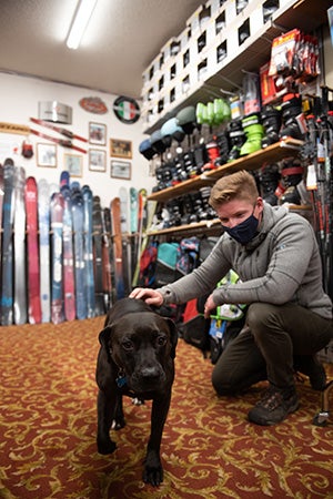 Dakota the dog in a ski shop with a person