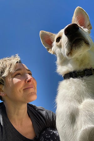 Photo looking up a Hanz the dog and a person smiling at him