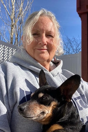 Ogden the dog being held by a woman