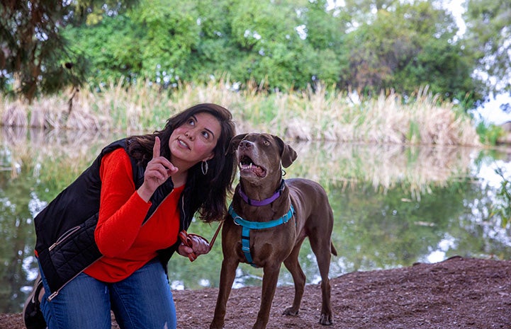 Trish Escobedo and Jarvis the dog looking up at something