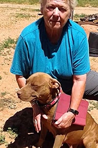 Frannie the dog next to a person wearing a blue shirt