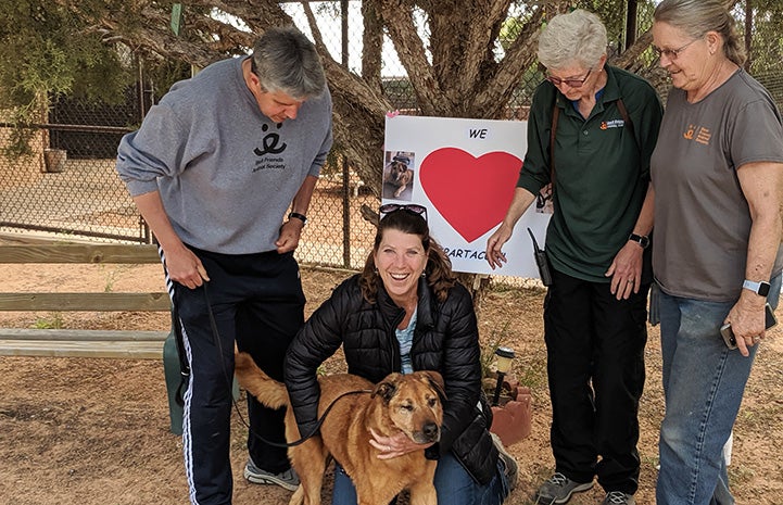 Caregivers seeing Spartacus the dog off when he was adopted