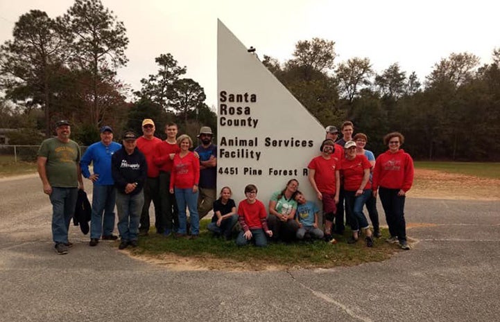 Group of people in front of the Santa Rosa County Animal Services sign