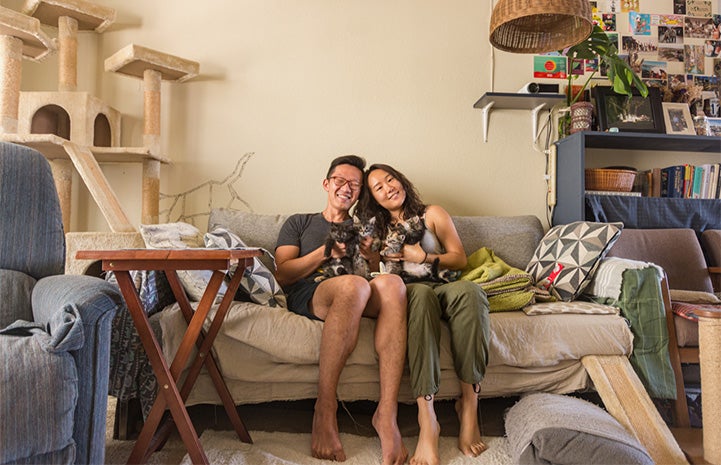 David Soobin Lee and Yomi sitting on a couch holding their foster kittens