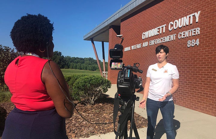 Woman being interviewed on camera in front of the Gwinnett County Animal Welfare and Enforcement building