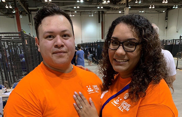 Couple wearing orange Best Friends T-shirts got engaged at the Houston Super Adoption event