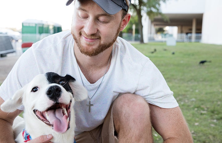 Dakota Jones went home just about the cutest black and white dog with a huge smile