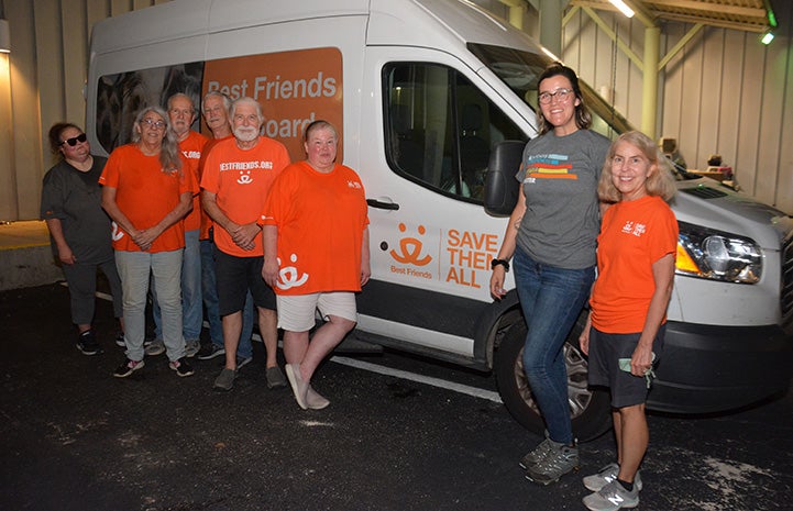 Best Friends staff and volunteer transporters to San Antonio with a van behind them