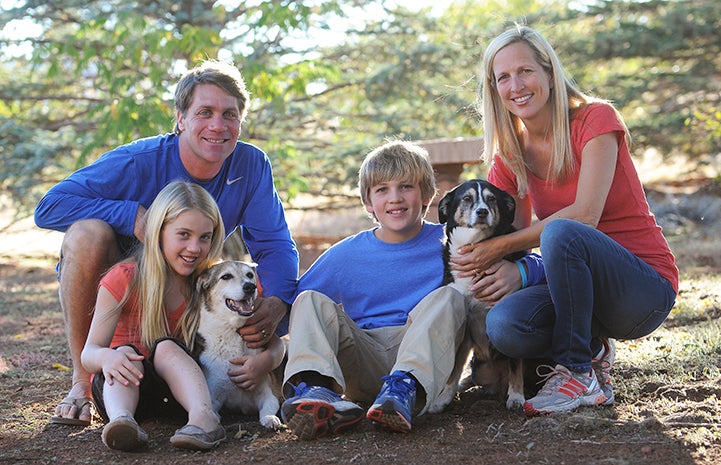 The Scharf family posing with two dogs from their 2012 trip
