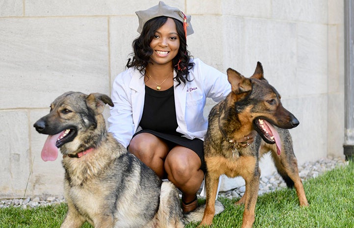 Dr. Tierra Price posing with two shepherd dogs