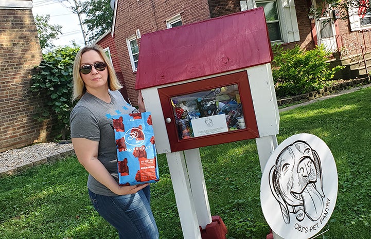 Carolyn Alonzo standing in front of the pet food/supply pantry