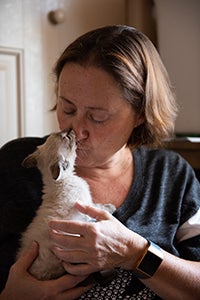 Wendy Gallant holding Vern the kitten as he gives her a kiss on the nose