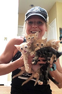 Jill holding an entire litter of foster kittens
