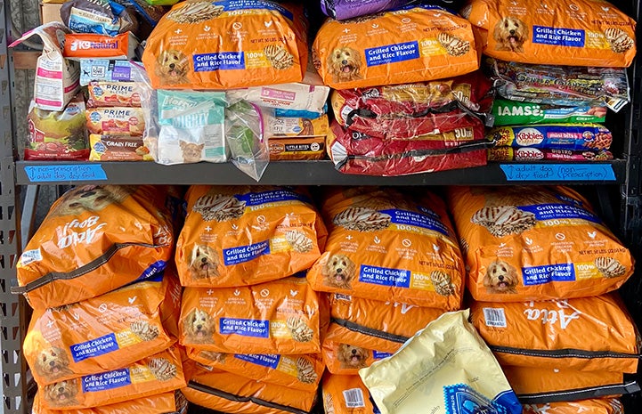 Multiple bags of dog food stacked on top of each other