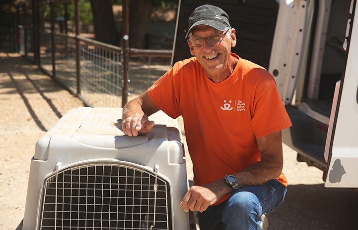 Don Clark next to the crate containing Mary Jane the pig